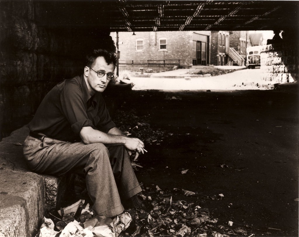Algren sitting beneath a viaduct in Chicago